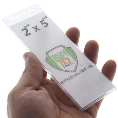 A hand holding a **Clear Ticket Holder for 2 1/8 X 5 5/8 Inch (Ticketmaster Size) Concert and Sporting Event Tickets & Credentials (SPID-1140)** with the text "2 x 5 5/8" and "SPECIALIST ID INC" alongside a shield logo, perfect for displaying collectible concert tickets or sporting event tickets.