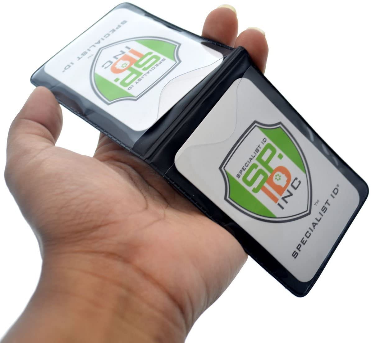 A hand holds an open black Magnetic Vertical Double Pocket Badge Holder (1835-1115) displaying two Specialist ID cards with green and orange logos.
