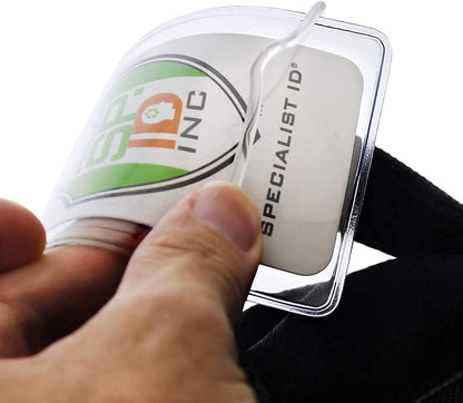 A hand holding Clear Plastic Luggage Identification Tags with Loops Included - Business Card or Photo Insert (Locking Top) with a Specialist ID card inside, secured by durable loops similar to those on luggage tags.