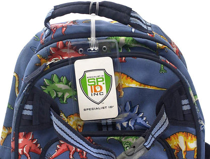 A blue backpack with a dinosaur pattern and a Clear Plastic Luggage Identification Tags with Loops Included - Business Card or Photo Insert (Locking Top) attached to the top handle. The tag, featuring a green shield logo, reads "SP ID, INC" and "SPECIALIST ID". The secure loops keep it firmly in place.