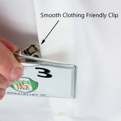 A close-up of a person clipping a 4 x 3 Horizontal Event Badge Holder with Clothing Friendly Bulldog Clip - Clear Vinyl, Horizontal & Durable (SPID-1440) onto a white shirt using a smooth, durable plastic vinyl clip.