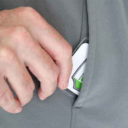A hand places a rectangular card into the pocket of a gray garment, securely sliding it into a Clear Vinyl Business Card Holder - Medicare Card Protective Sleeve (1840-3505).