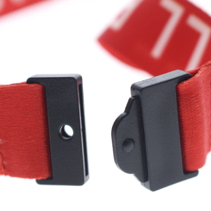 Close-up of a red Hall Pass Lanyard - Safety Breakaway Lanyards with Swivel Hook (SPID-2190) with black plastic connectors and a breakaway clasp for added school security. Sold by Specialist ID.