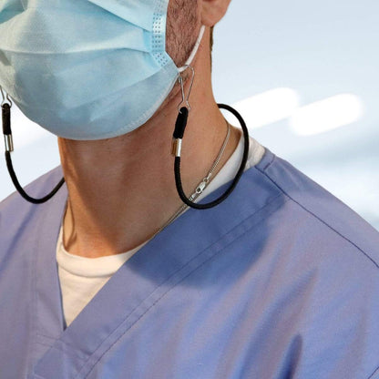 A person wearing a surgical mask secured with an Adjustable Length Double Ended Lanyard - Handy & Convenient Event Badge Holder & Hanger with 2 Clips and dressed in a blue scrub top. The background is blurred.