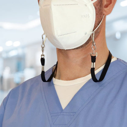 A person wearing a KN95 mask with an Antimicrobial Lanyard with Two Clips - Short Length Double Clip Lanyard with Safety Breakaway - 25 Inch Perfect Size for Students & Adults (SPID-2360) attached to it, dressed in blue medical scrubs.