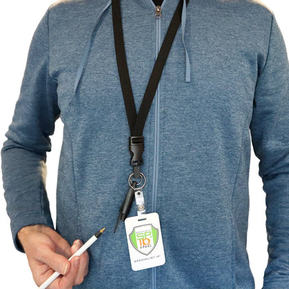 Person in a blue zip-up hoodie is wearing a company ID badge around their neck on a black Lanyard with Pen and ID Badge Holder - All in One Neck Lanyards (SPID-2380). The ID badge bears a logo with "SPC ID INC" written on it. The person holds a small tool and the lanyard badge features a convenient breakaway design for safety.