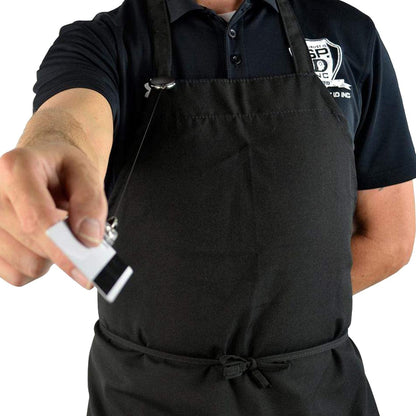 Person in a black apron holding a name badge with a Carabiner Badge Reel - Premium Retractable Oval Badge Holder with Carabiner Clip for Belt Loops & Purse Straps (2120-70XX) towards the camera.