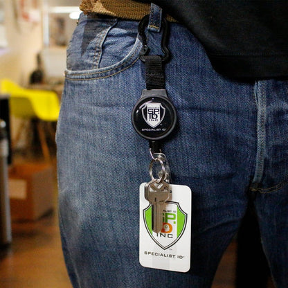 A person wearing jeans with a key and ID card attached to a Heavy Duty SPID Key-Bak Mid-Size Carabiner Retractable Badge Reel with Card Strap & Key Ring (SPID-3330), clipped securely to their belt loop.