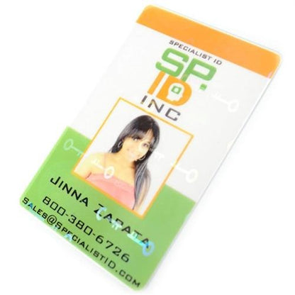A plastic ID badge featuring a woman's photo, the text "SPECIALIST ID INC.," "JINNA ZAPATA," a phone number, and an email address, comes with a Self Adhesive Holographic Overlay - Shield and Key for added anti-counterfeiting protection.