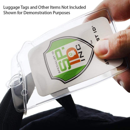 A hand is holding a clear plastic luggage tag with a white card inside, featuring a green and orange logo. The text above reads "Luggage Tags and Other Items Not Included Shown for Demonstration Purposes." Clear Plastic Luggage Loop Straps 6 Inch - Durable Worm Loops (2410-2000) ensure secure attachment for all your travel needs.
