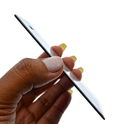 A hand holding a thin, rectangular electronic device, possibly a smartphone, with Color Coded Backpack ID Tags with Loop - Semi Rigid Holds a Business Card or Included Identification Card (1845-200X) in the background.