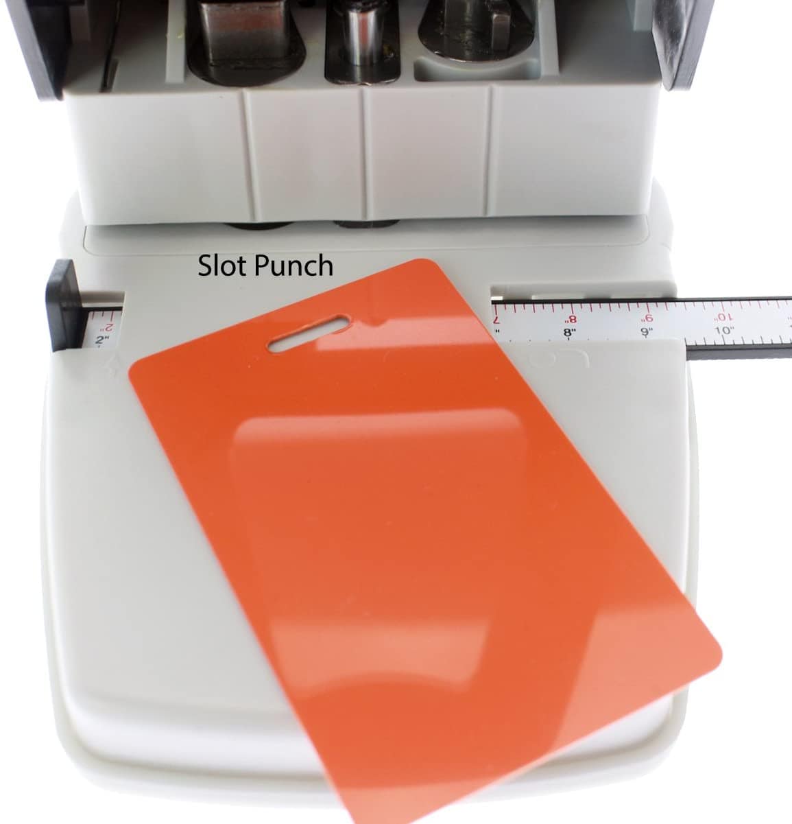 A 3-in-1 ID Card Slot Punch w/ 1 hole Punch and Corner Rounder with an adjustable guide and ruler is shown. An orange plastic ID card with a punched slot is placed on the machine's surface.