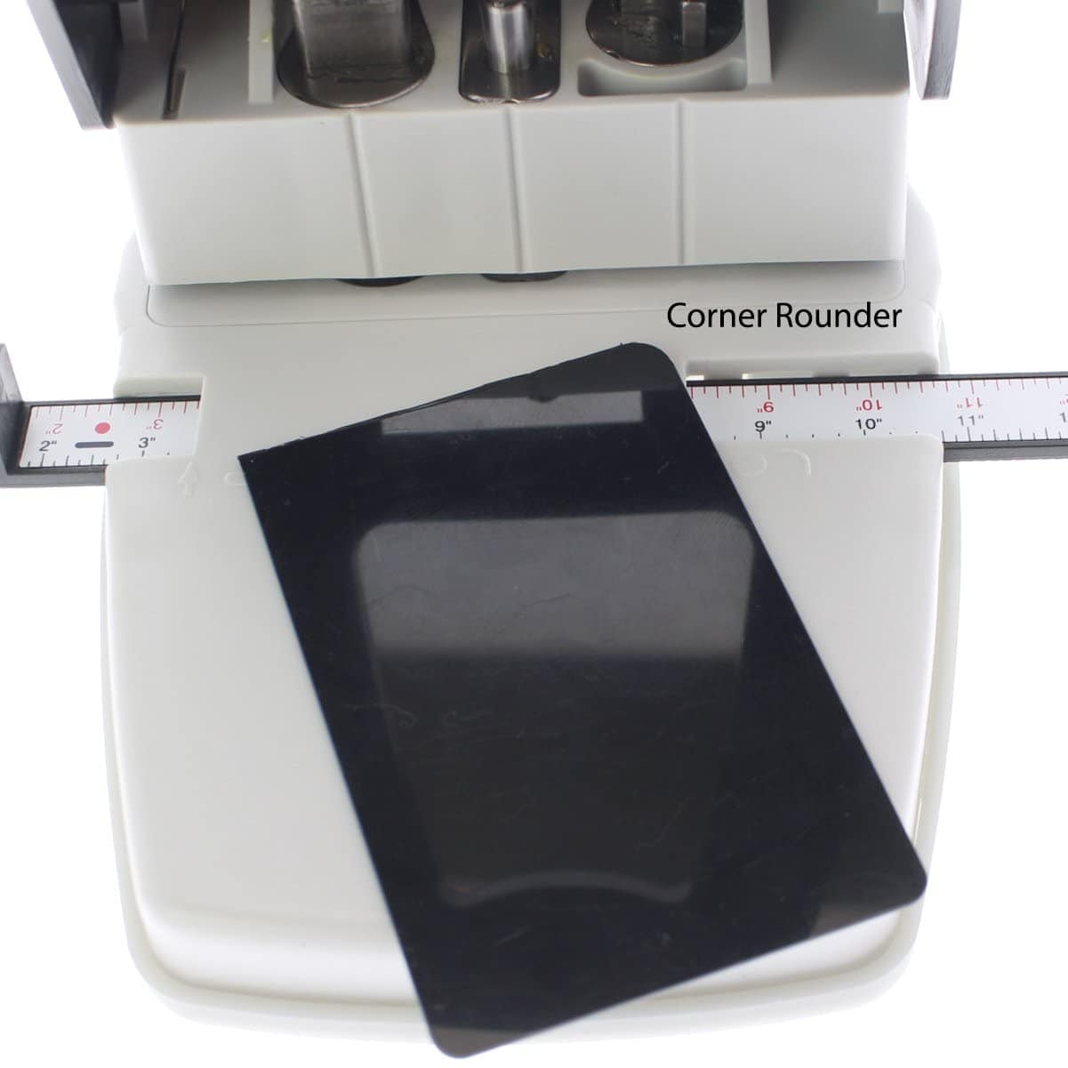 A 3-in1 ID Card Slot Punch w/ 1 hole Punch and Corner Rounder with a black card positioned on a measuring scale in front, featuring an adjustable guide for precision. The label "Corner Rounder" is visible on the top machine part, making it perfect for rounding ID cards.