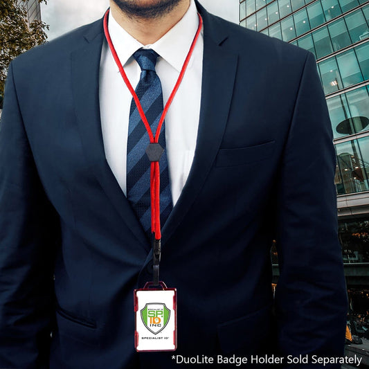 A person in a blue suit with a striped tie wears a red Metal Detector Friendly Heavy Duty Lanyard with Diamond Slider, Breakaway Clasp & Quick Release Plastic Hook - MRI Safe (2135-45XX) holding a badge reading "SPL" in a high-rise building background. Text at the bottom reads "*DuoLite Badge Holder Sold Separately".