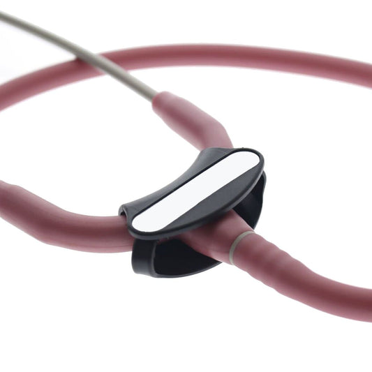 Close-up of a pink Littmann Cardiology stethoscope with a black and white Yoke Stethoscope ID Tags - Blank with Write on Surface (Cardio & Cardiology Compatible) (SPID-9760) attached to the tubing, ideal for medical professionals.