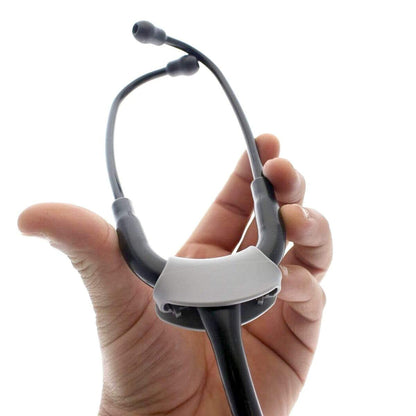 A medical professional's hand holds a Yoke Stethoscope ID Tag - Blank with Write on Surface (Cardio & Cardiology Compatible) (SPID-9760) upright against a plain white background. Sold by Specialist ID.