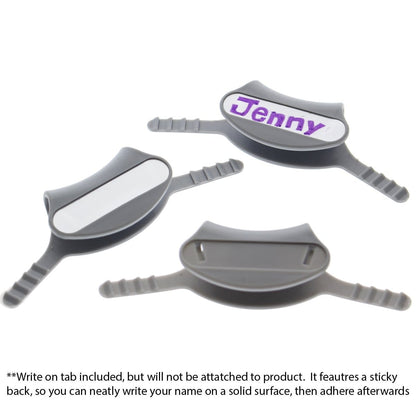 Three gray Yoke Stethoscope ID Tags - Blank with Write on Surface (Cardio & Cardiology Compatible) (SPID-9760) with sticky backs suitable for medical professionals. One tag has "Jenny" written on it in purple. Instructions at the bottom of the image explain that the write-on tab is included but not attached, perfect for use as Stethoscope ID Tags.