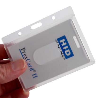 A hand holds an HID ProxCard II in a transparent Horizontal 70 - 90 Mil ProxCard II / Thick HID Proximity Card Holder (SPID-PROX-H). The card is partially inserted, clearly showing the branding and card details.