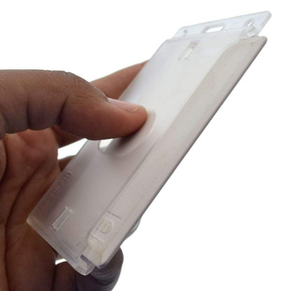 A hand holding a Vertical 70 - 90 Mil ProxCard II / Thick HID Proximity Card Holder (SPID-PROX-V) with a thumb pressing down on a clip, featuring a translucent plastic design for easy visibility.
