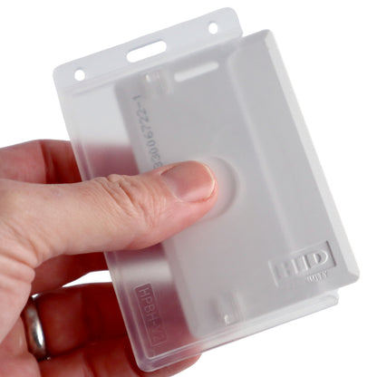 A hand holding a translucent plastic badge holder showing the "HID" brand and model number "SPID-PROX-V," specifically designed to accommodate the Thick Proximity Card.