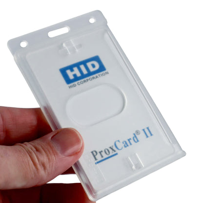 A hand holds a Vertical 70 - 90 Mil ProxCard II / Thick HID Proximity Card Holder (SPID-PROX-V) containing a ProxCard II in a transparent plastic holder.