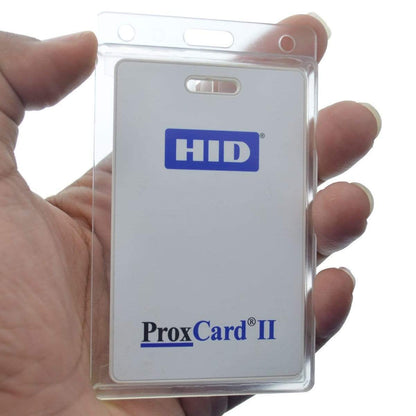 A hand holds a thick Proximity Card inside a Vertical 70 - 90 Mil ProxCard II / Thick HID Proximity Card Holder (SPID-PROX-V). The card displays the text "HID ProxCard II" prominently.