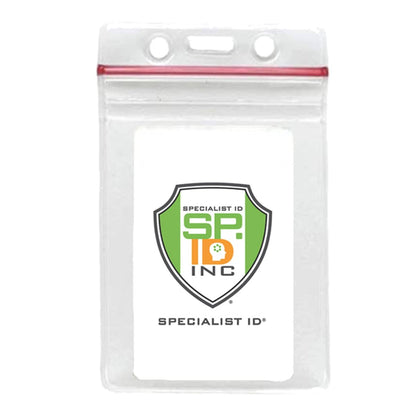 Clear Vertical Vinyl ID Holder with a Zipper Top (VBH-V-ZIP) with a white insert displaying a shield-shaped logo with "SPECIALIST ID INC" text in green, orange, and black. This clear vertical vinyl ID holder features a red zip-lock seal at the top and is designed to fit credit card size badges perfectly.