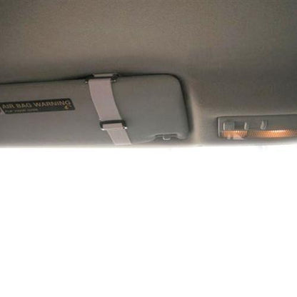 A vehicle sun visor with an airbag warning label is shown, along with the edge of the vehicle's roof lining, an interior light, and a Clear Fuel Card Holder for Visor with Elastic Band.